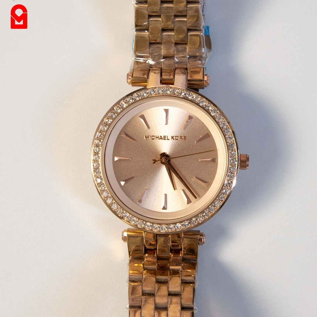 Close-up of rose gold ladies watch dial with crystal bezel and elegant minimalist design.