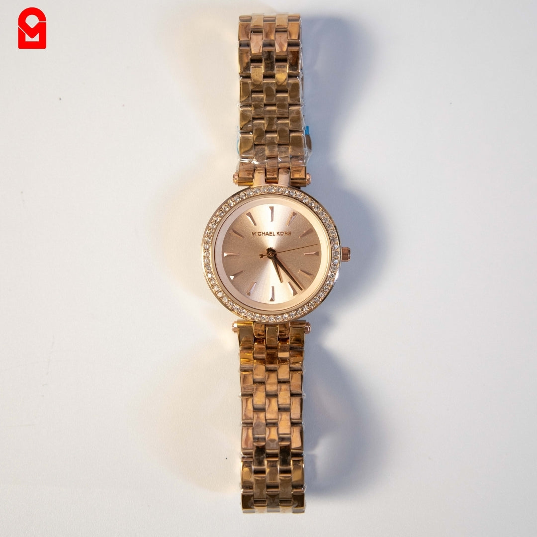 Rose gold women’s luxury watch with crystal bezel and stainless steel bracelet on white background.