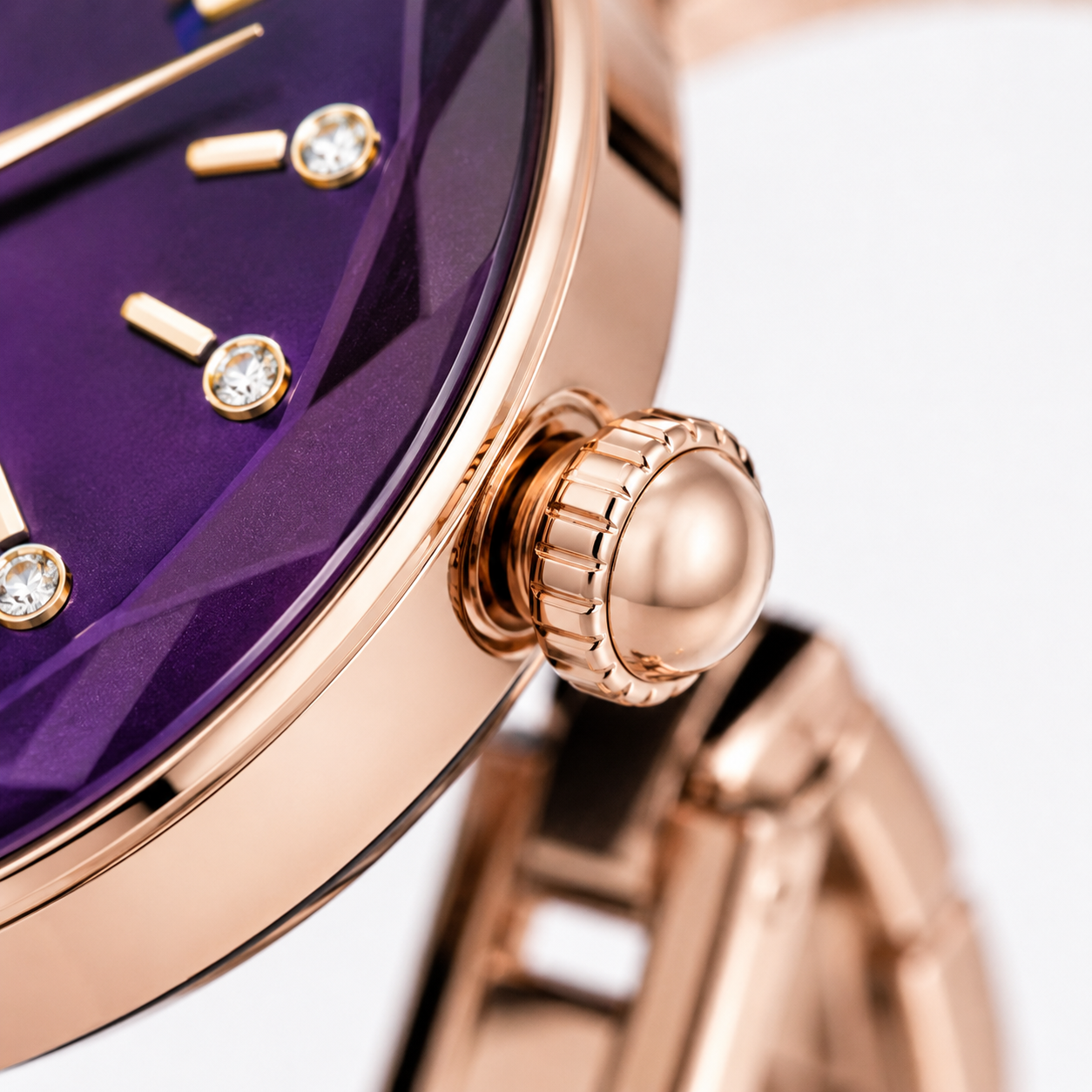 Rose gold women's analog watch with a faceted purple dial, crystal hour markers, polished crown, and elegant metal bracelet