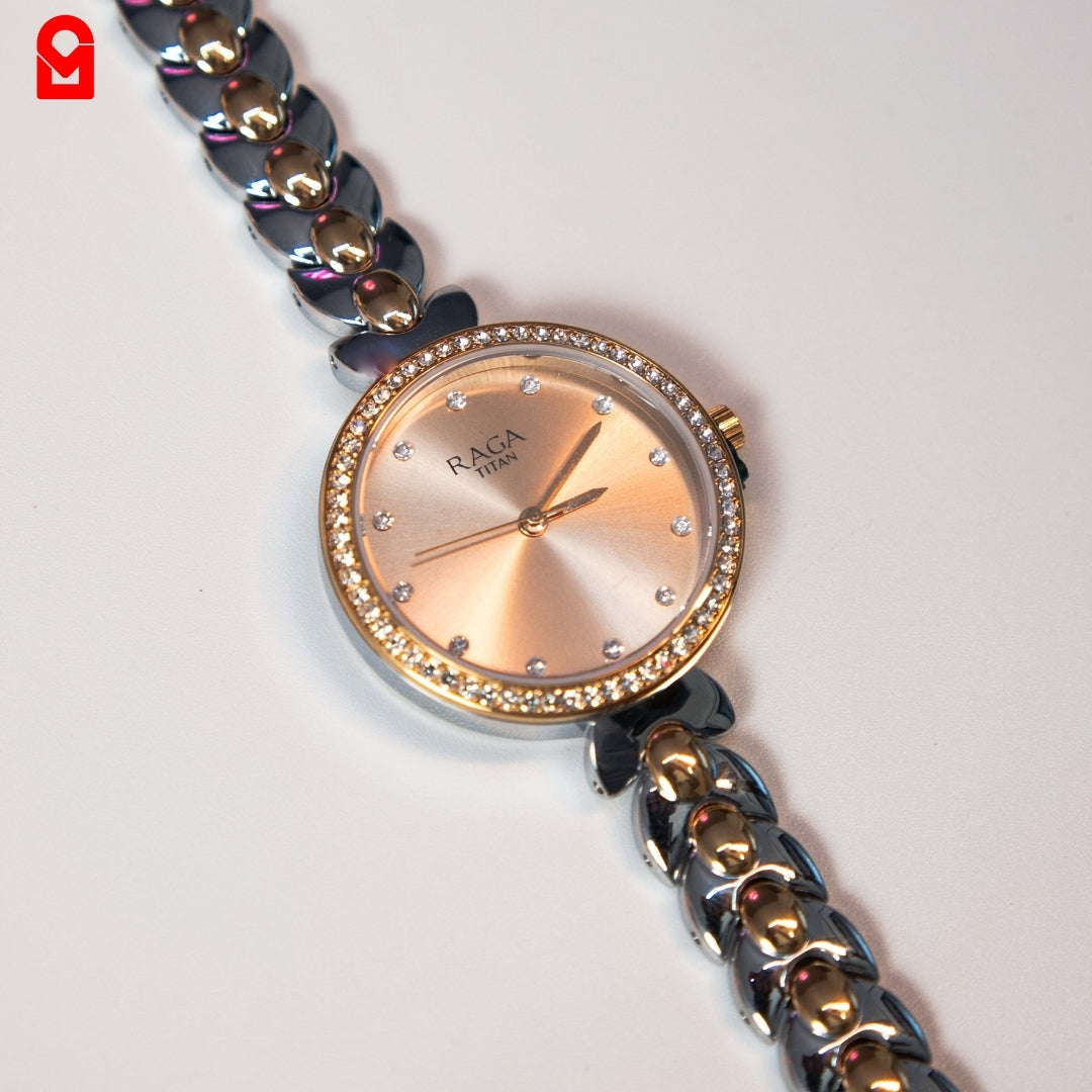 Close-up of women’s analog bracelet watch showing crystal bezel and steel bracelet strap.