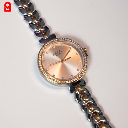 Close-up of women’s analog bracelet watch showing crystal bezel and steel bracelet strap.