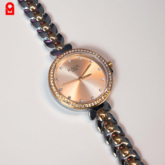 Close-up of women’s analog bracelet watch showing crystal bezel and steel bracelet strap.