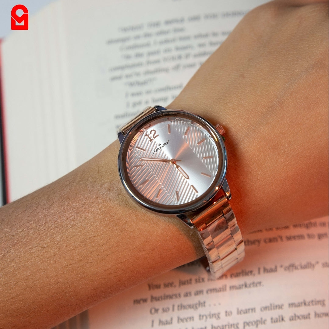 Women’s rose gold bracelet watch worn on wrist showing minimalist analog dial design.