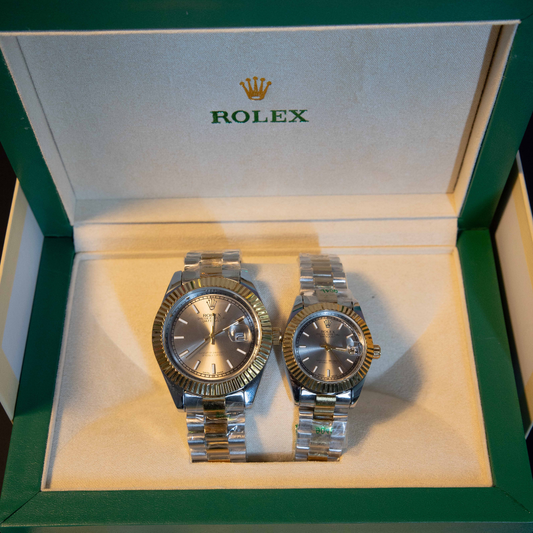 Silver dial two-tone couple watch set with stainless steel bracelet displayed in luxury watch box