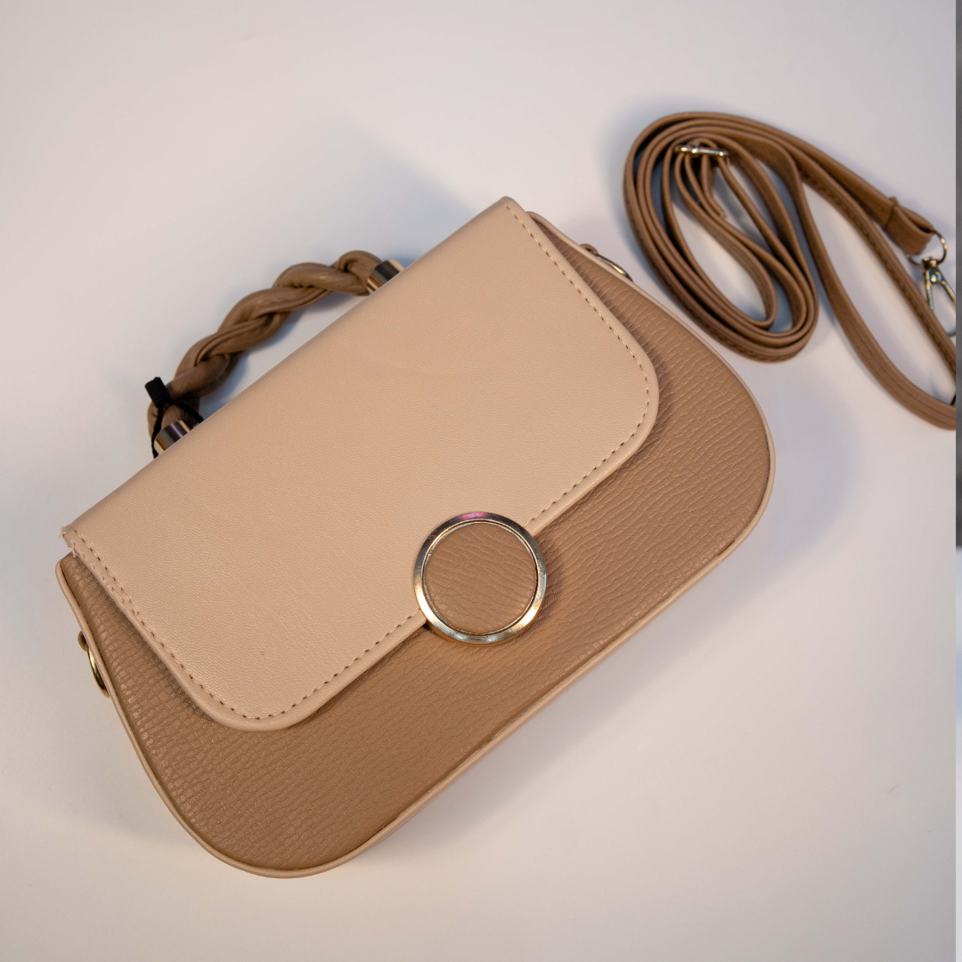 Tan and beige two-tone ladies crossbody bag with structured shape.