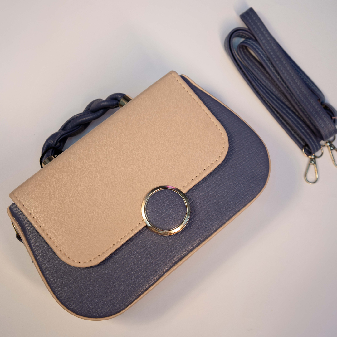 Navy blue and beige women’s sling bag with modern flap closure.