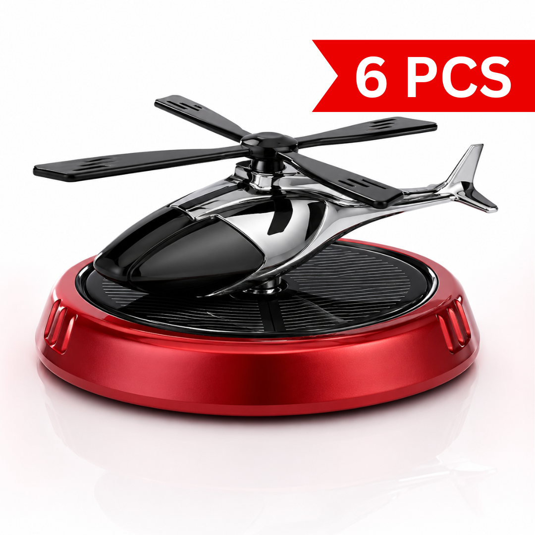 Close-up product photo of a solar-powered helicopter car air freshener featuring a chrome black helicopter, four-blade rotor, integrated solar panel, and metallic red base on a clean white background. Modern dashboard fragrance accessory with elegant automotive styling.