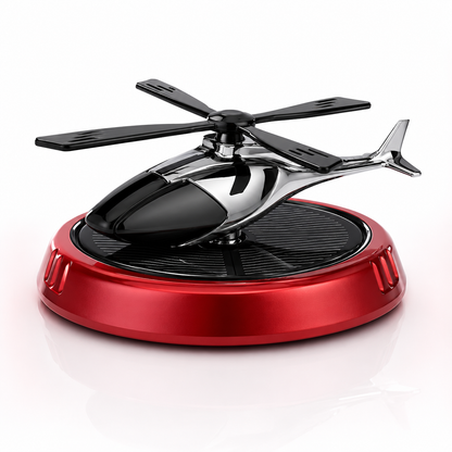 Close-up product photo of a solar-powered helicopter car air freshener featuring a chrome black helicopter, four-blade rotor, integrated solar panel, and metallic red base on a clean white background. Modern dashboard fragrance accessory with elegant automotive styling.