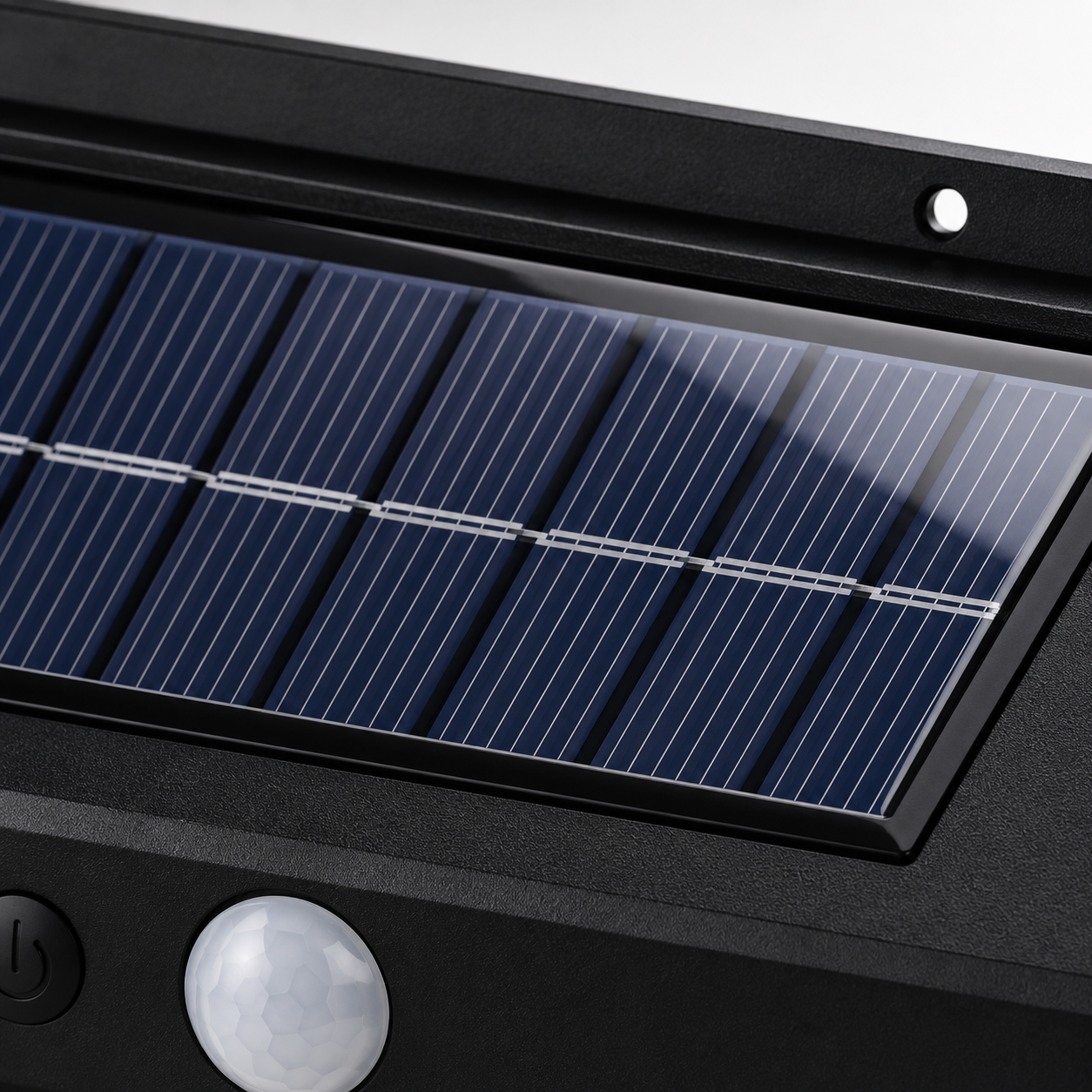 Macro close-up of the high-efficiency integrated solar panel mounted on the top of the outdoor wall lamp, showing premium photovoltaic cells, textured black housing, and built-in PIR motion sensor.