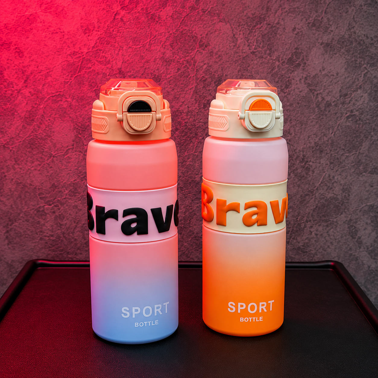 SportSip Kids Water Bottle available in pink-blue and orange gradient colours with flip-top straw lid and sporty design.