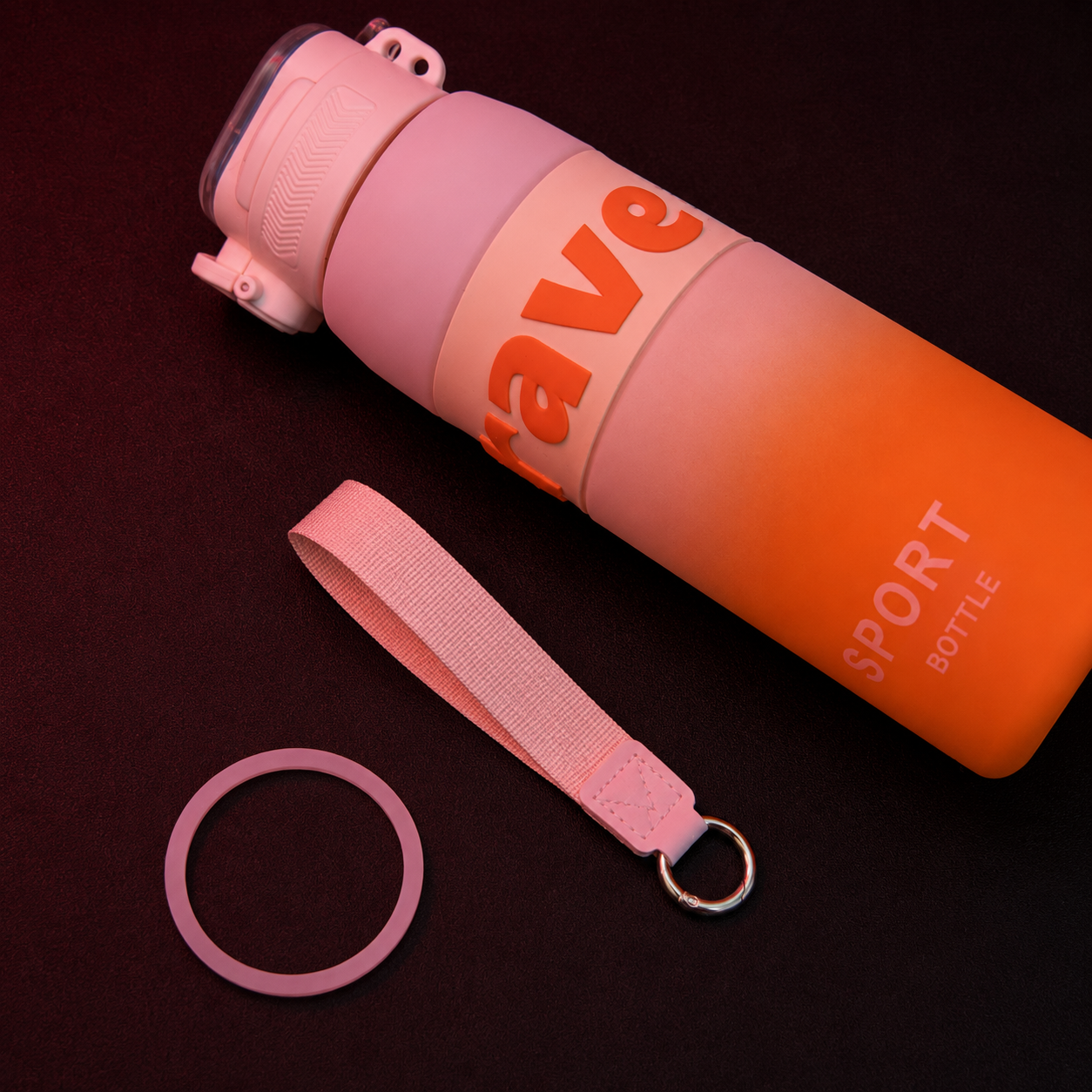 SportSip Kids Water Bottle with detachable wrist strap, silicone ring accessory and gradient orange sports bottle design.