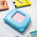 Detailed close-up of the light blue, rounded talking card reader with its pink card slot and control buttons, next to the 'toothbrush' and 'mother' flashcards.