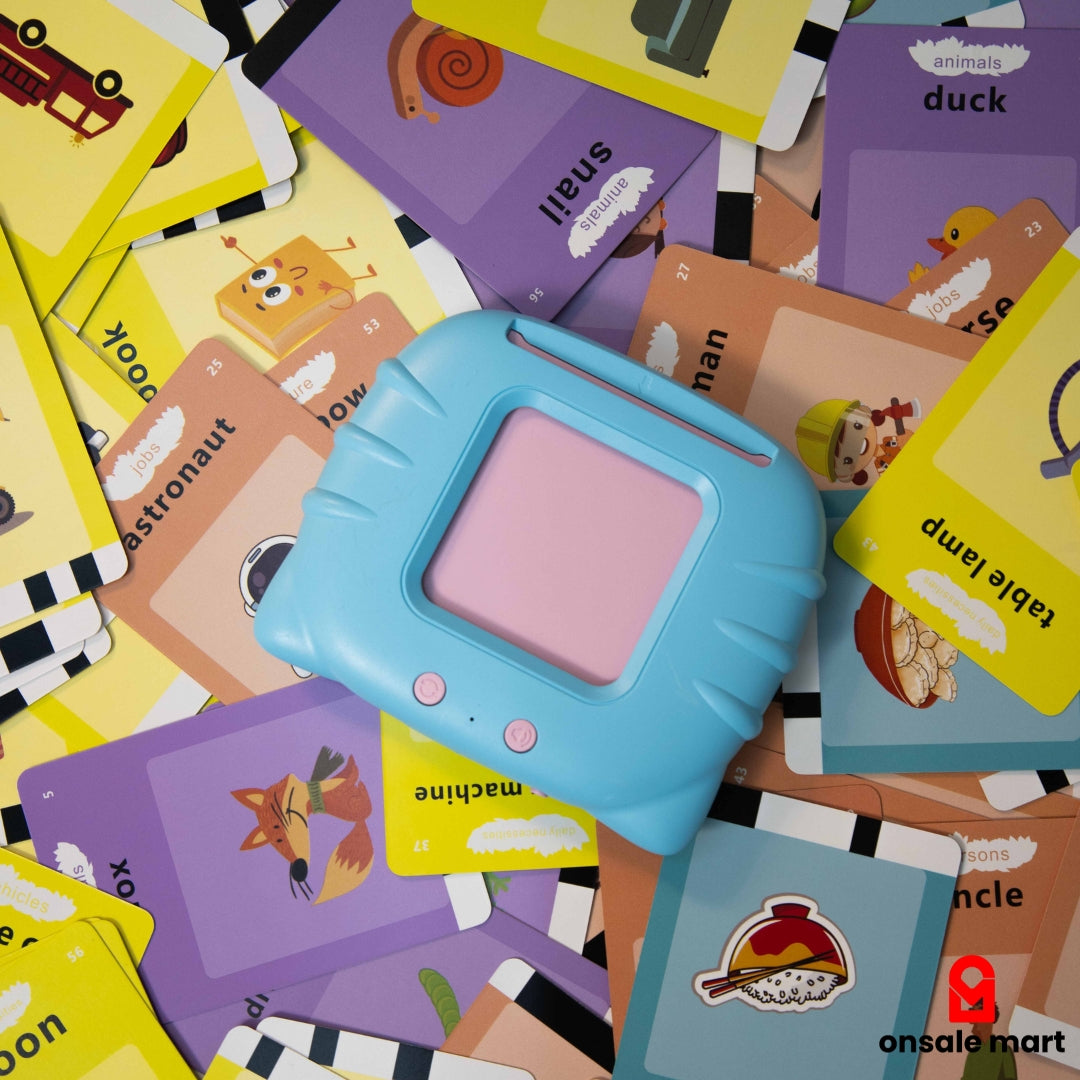 Overhead view of the blue talking card reader resting on a scattered pile of colorful flashcards, showcasing the wide range of vocabulary.