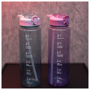 Motivational water bottles in grey blue and purple color options featuring time markers, straw lids and hydration reminder design