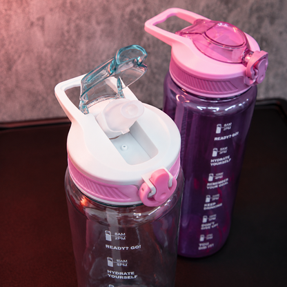 Close-up of motivational water bottle with flip-top straw lid, secure lock mechanism and carry handle, reusable hydration bottle for gym, school and travel