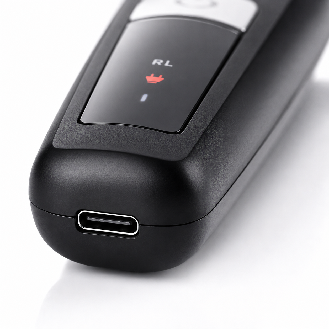 Close-up macro image of the Rock Light RL-TM9200 Professional Hair Trimmer featuring a USB Type-C charging port, matte black body, LED charging indicator, and premium textured finish