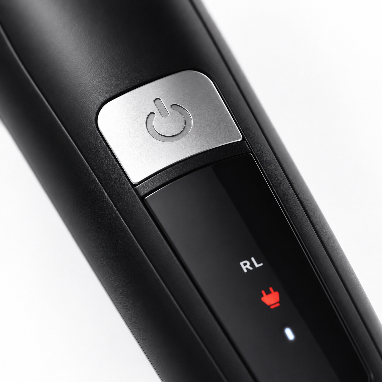 Macro view of the Rock Light RL-TM9200 hair trimmer showcasing the metallic power button, LED charging indicator, sleek matte black housing, and modern ergonomic design with premium detailing.