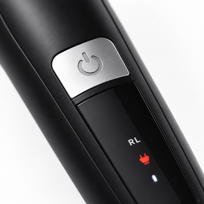 Macro view of the Rock Light RL-TM9200 hair trimmer showcasing the metallic power button, LED charging indicator, sleek matte black housing, and modern ergonomic design with premium detailing.
