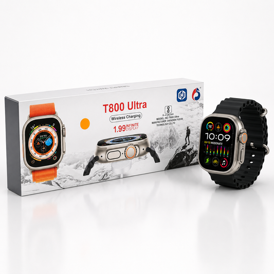Ultra-style 49mm smartwatch with a space gray aluminium case and black silicone strap displayed beside its retail packaging on a clean white background. Features a large edge-to-edge display, orange-accent digital crown, side action button, wireless charging support and premium modern design.