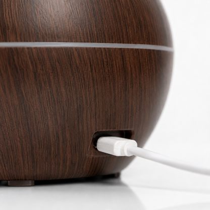 Close-up of the USB charging port on a wood-grain ultrasonic aroma humidifier, highlighting the DC 5V USB-powered connection for convenient everyday use.