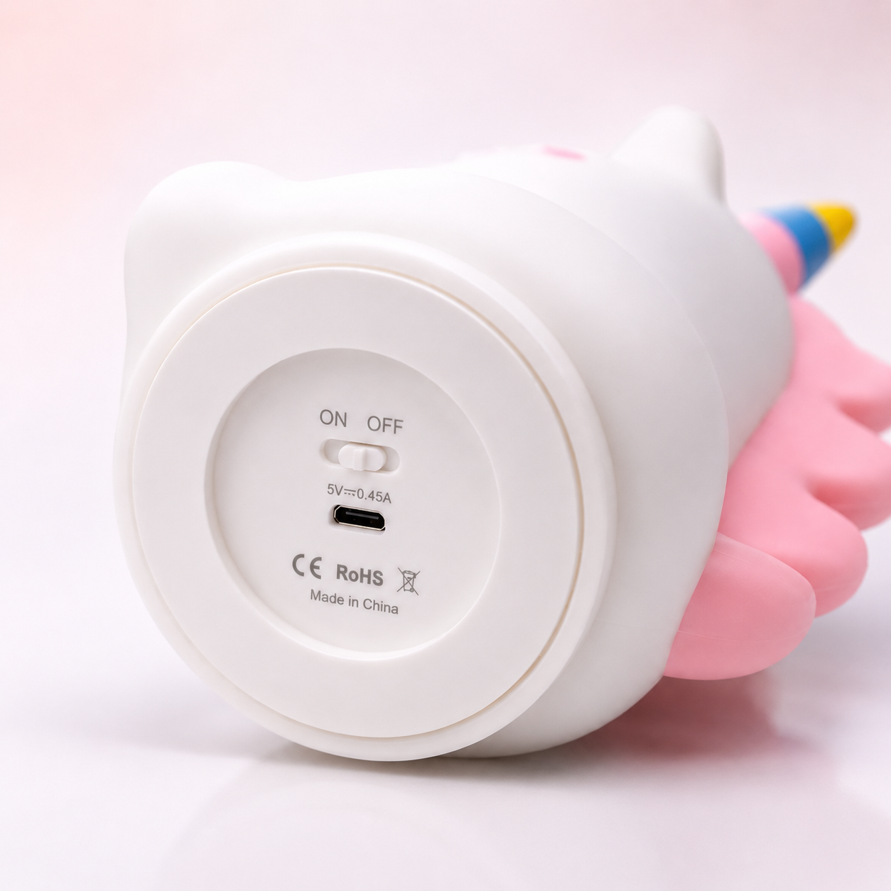 Close-up view of unicorn silicone night lamp bottom with ON/OFF switch and USB charging port