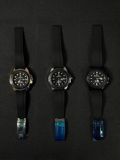 Luxury replica watch collection featuring automatic dive watches with black rubber Oysterflex-style straps on a dark background.