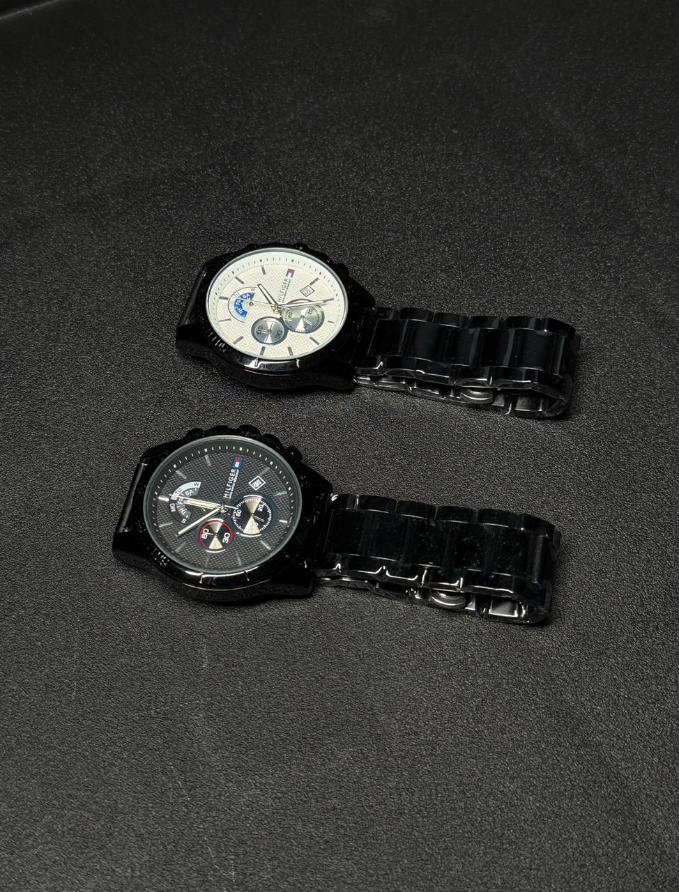 Replica watch set featuring white and black dial chronograph-style watches with black stainless steel bracelets on dark textured background