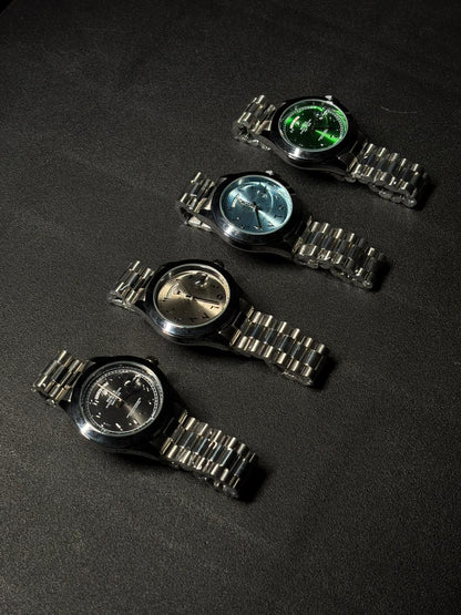 Collection of replica luxury watches with black, silver, ice blue and green dials featuring stainless steel bracelets and day date function