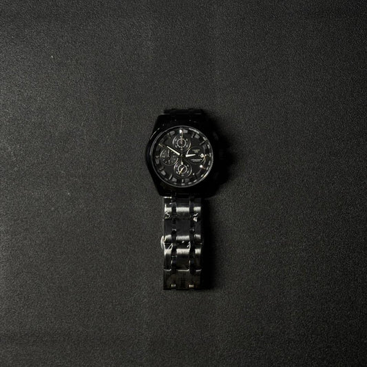 Men's black replica watch with stainless steel bracelet and chronograph-inspired analog dial, luxury fashion wristwatch product image on dark surface