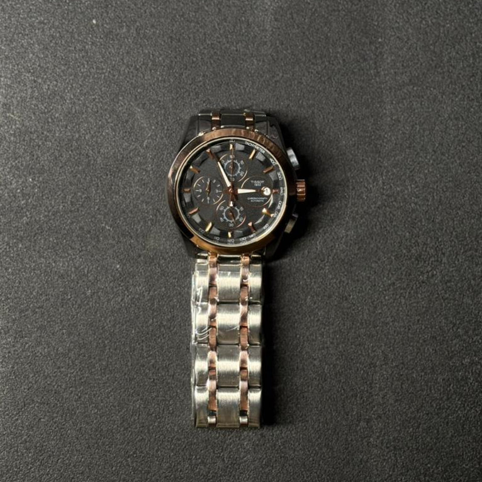 Replica chronograph watch with rose gold and silver stainless steel bracelet, black multi-dial analog display, luxury men's fashion wristwatch on dark textured background
