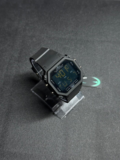 Black replica digital sports watch with octagonal LED display, rugged case design and comfortable silicone strap on display stand