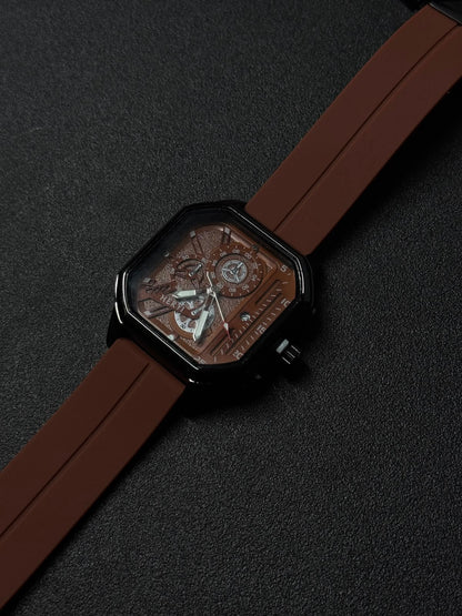 Brown silicone strap replica watch close-up showing square black case, textured skeleton dial, and premium fashion timepiece details.