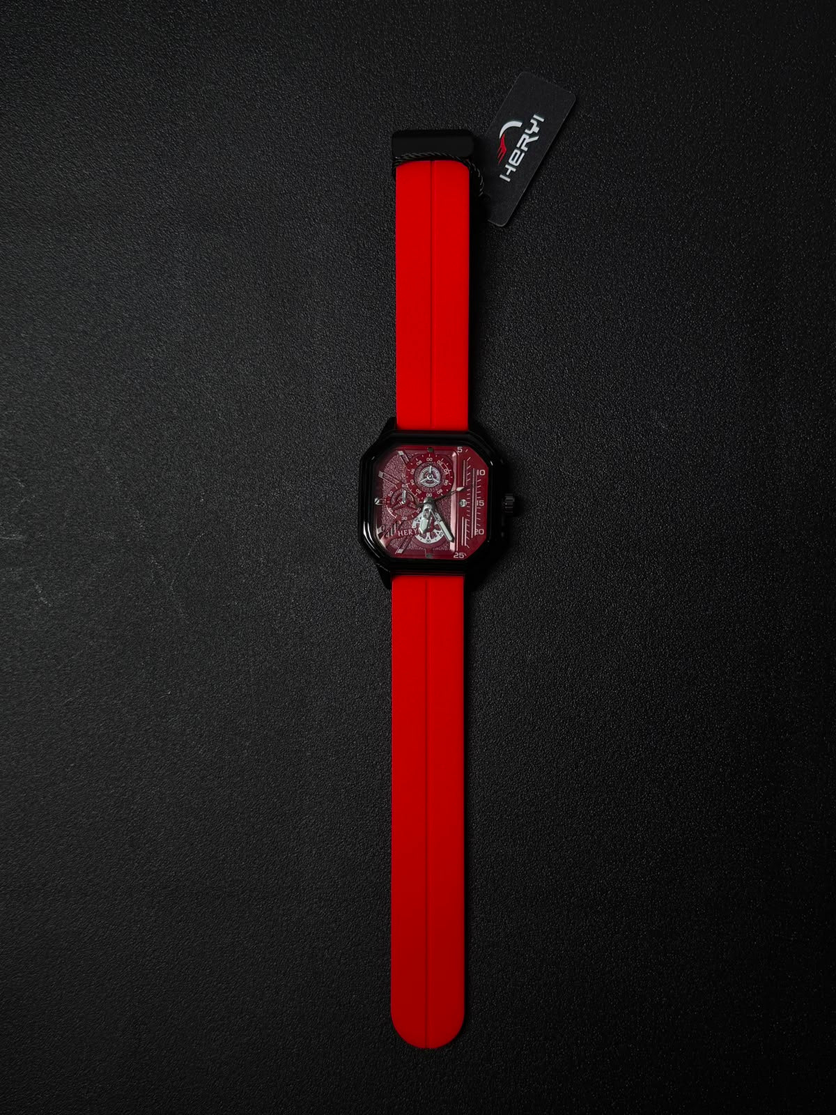 Red silicone strap replica watch with square black case, red skeleton dial, and bold contemporary fashion watch styling.