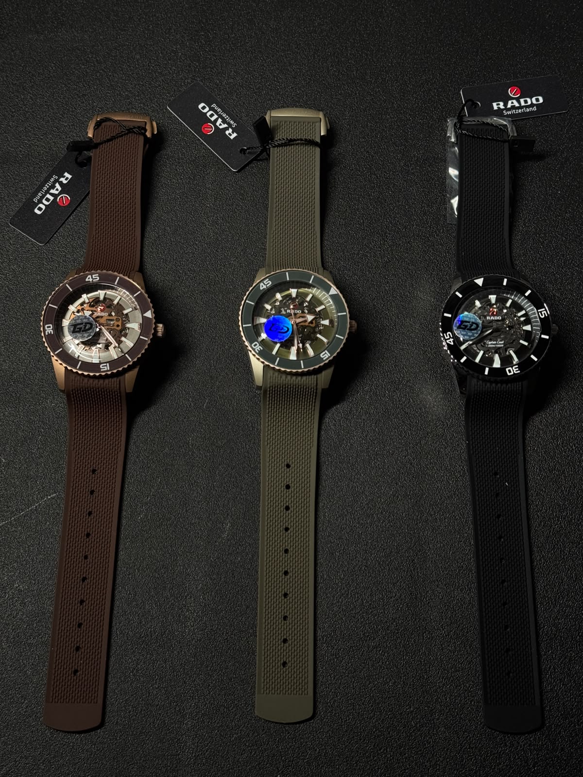 Premium replica watches in brown, olive green, and black colors featuring skeleton dials, silicone straps, and sport luxury design.