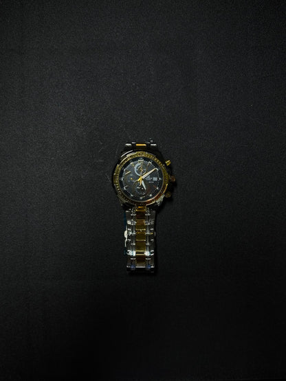 Black and gold replica men's watch featuring a chronograph-style dial, metal bracelet and premium luxury design on black background.