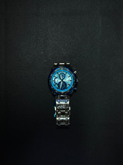 Blue dial replica chronograph watch with stainless steel strap, sporty bezel and analog display photographed on a dark textured surface.