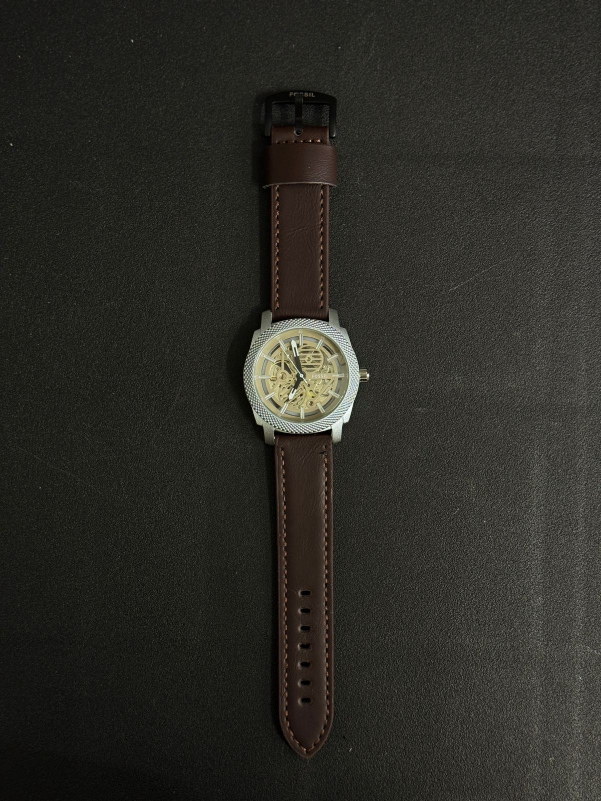 Premium replica watch with skeleton dial, silver textured bezel, brown leather strap, luxury-inspired men's analog wristwatch close-up
