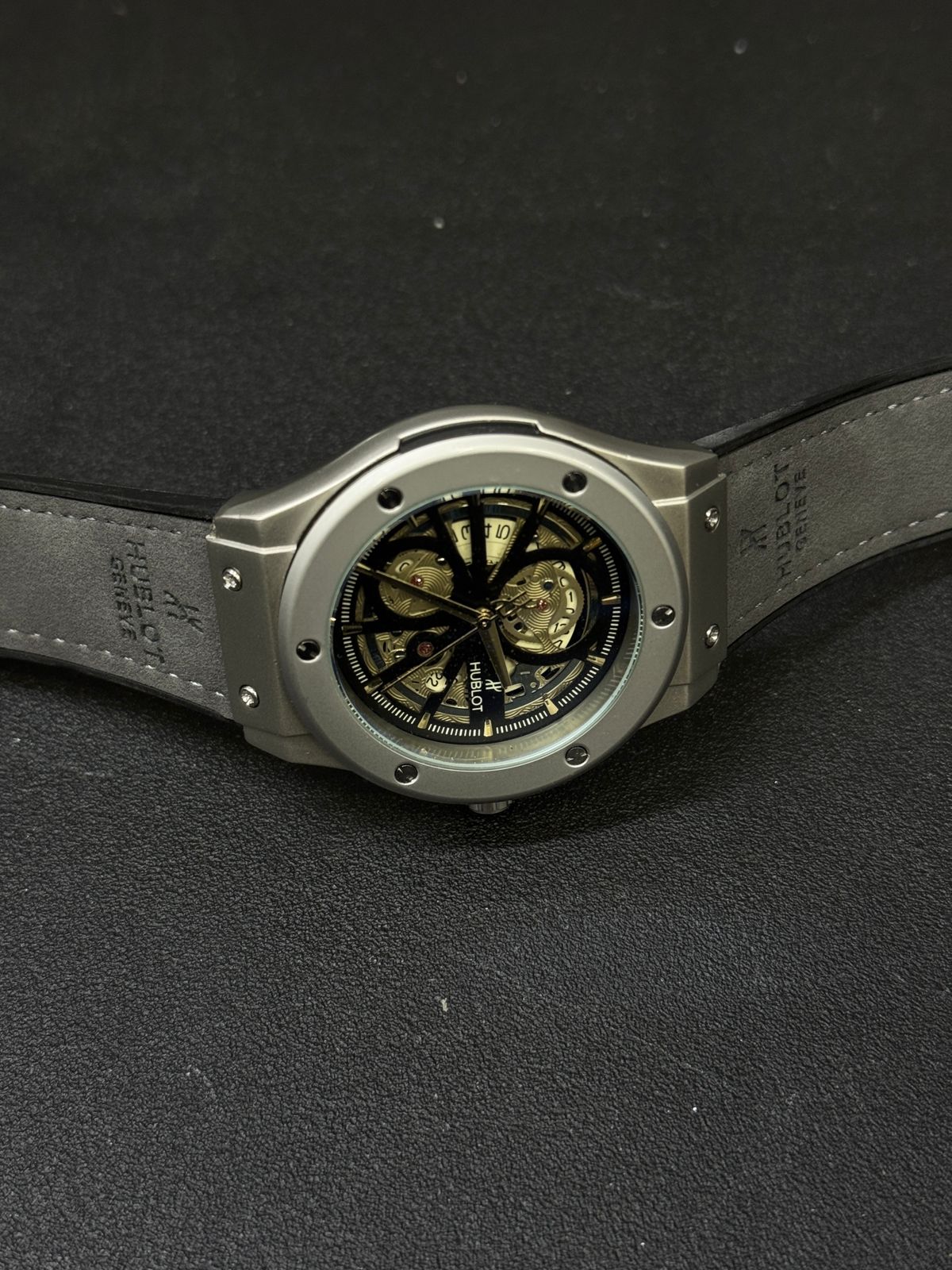 Luxury replica watch with skeleton dial, grey bezel, black leather strap, premium automatic-style design, men's fashion wristwatch