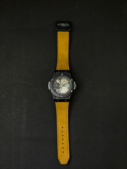 Full view of black replica watch with tan leather strap, skeleton gear dial, date display, luxury-inspired men's fashion watch on black surface