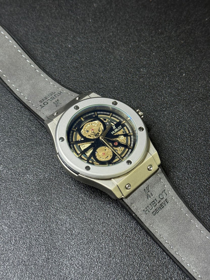 Premium replica watch featuring open skeleton dial, grey case, leather strap, luxury inspired men's wristwatch angled product view
