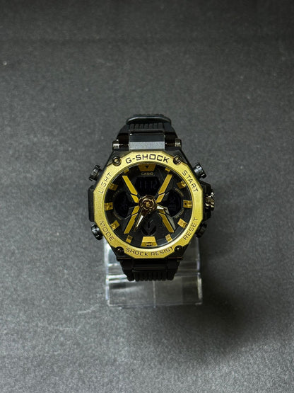Replica G-Shock style analog digital sports watch with black silicone strap, gold-tone bezel, oversized rugged dial and dual display for men