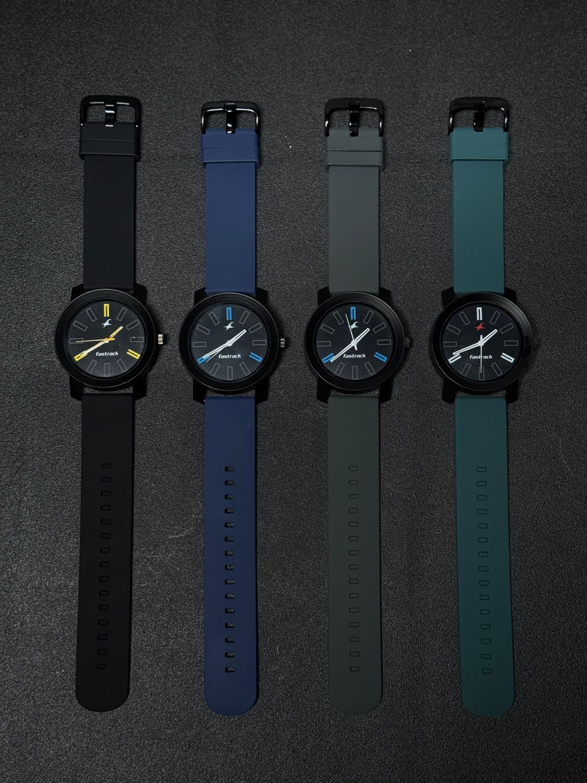Replica watch collection featuring black, blue, grey and teal silicone strap variants with minimalist black dials and modern analog design