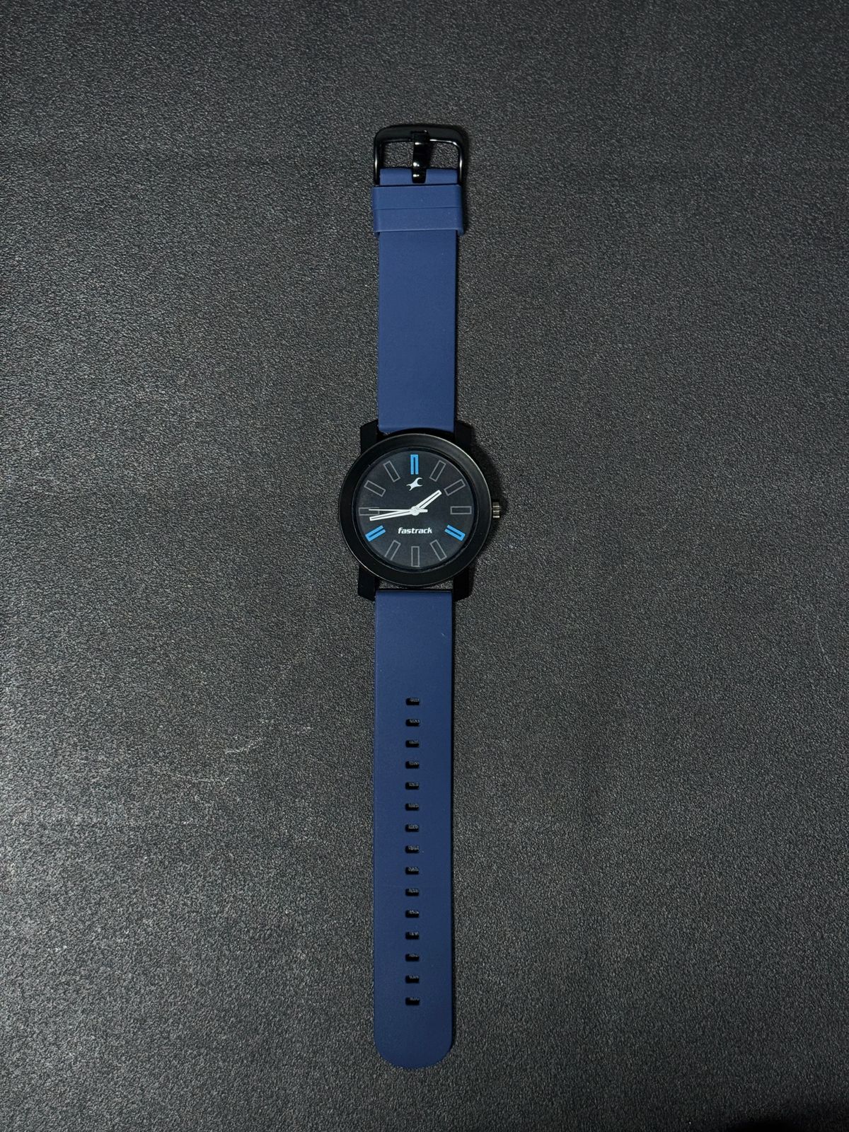 Blue silicone strap replica watch with black dial, blue accent hour markers, lightweight casual fashion wristwatch for everyday wear