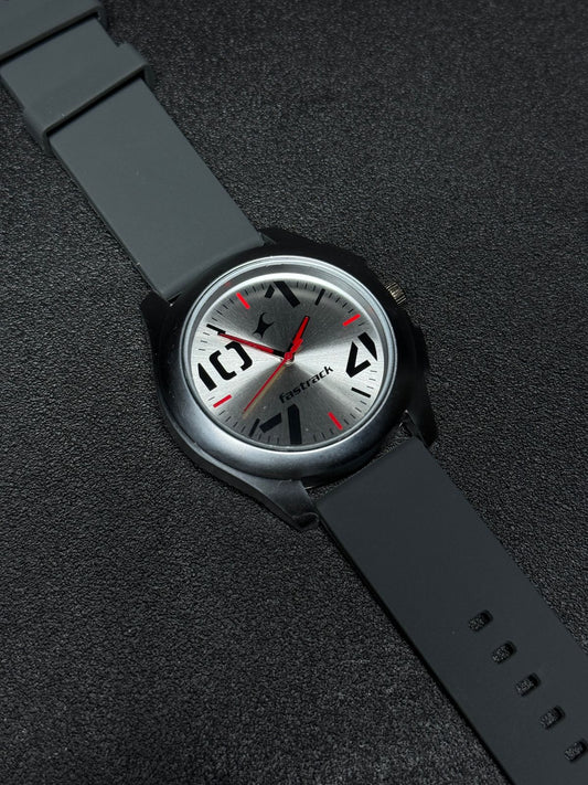Replica Watch with grey silicone strap, silver sunburst dial, black case, red hands and modern analog display, premium men's casual wristwatch product photography.