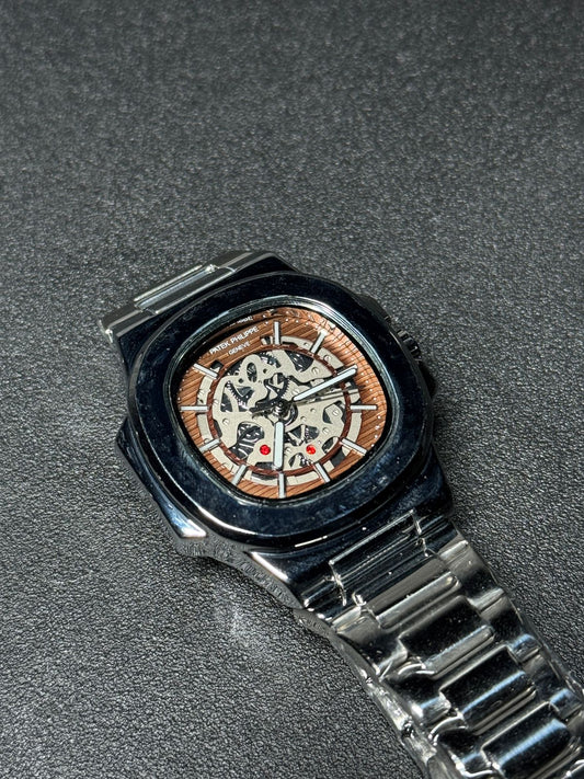 Replica watch with brown skeleton dial, stainless steel bracelet, luxury automatic-style design, black bezel wristwatch product photography
