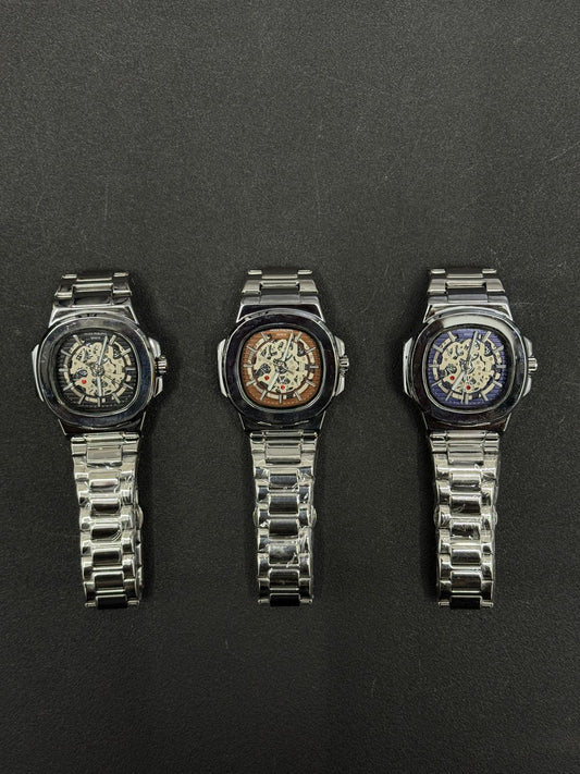 Replica watch collection featuring black, brown and blue skeleton dials with stainless steel bracelets, luxury men's wristwatch display