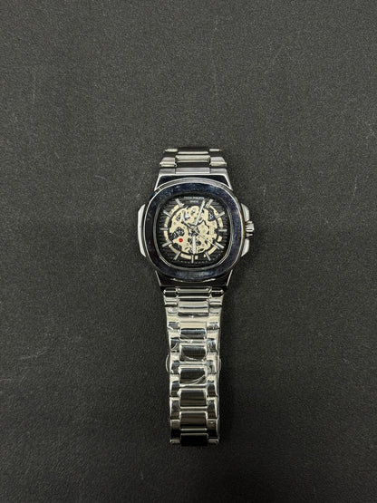 Replica watch with black skeleton dial and stainless steel bracelet, premium luxury-inspired men's wristwatch on dark background