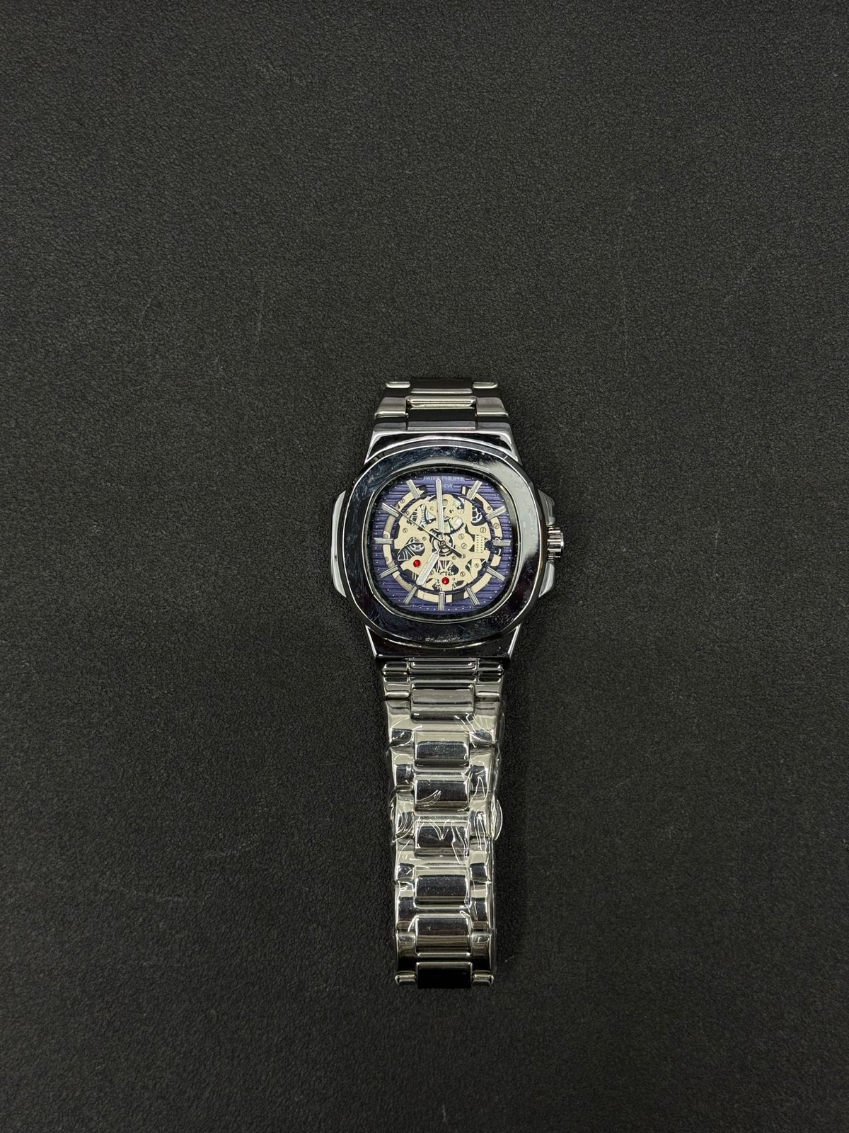 Replica watch featuring blue skeleton dial, silver-tone stainless steel strap, luxury automatic-style men's wristwatch product image