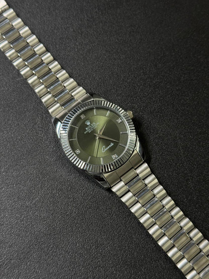 Silver watch with a green face on a black background