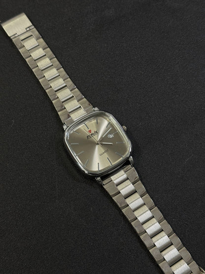 Silver wristwatch with a metallic band on a black background